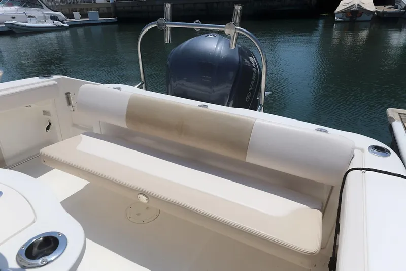 Slide: The Image of 2016 Robalo R222 Center Console boat with cushioned seating and Yamaha outboard motor. - 9