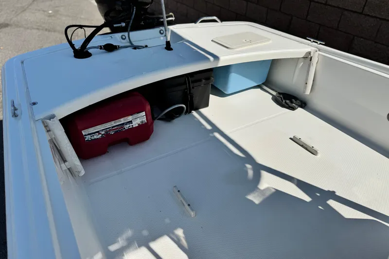 Slide: The Image of 2017 Mako Pro Skiff 17 CC boat interior with storage compartments and equipment. - 11