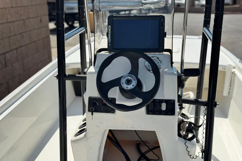 Slide: The Image of 2017 Mako Pro Skiff 17 CC boat console with steering wheel and navigation system. - 14
