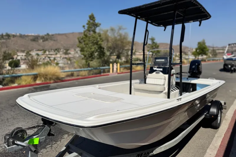 Slide: The Image of 2017 Mako Pro Skiff 17 CC boat on trailer, parked outdoors. - 3