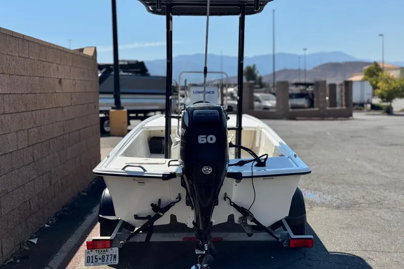 Slide: The Image of 2017 Mako Pro Skiff 17 CC boat with Mercury 60 engine, parked outdoors. - 4