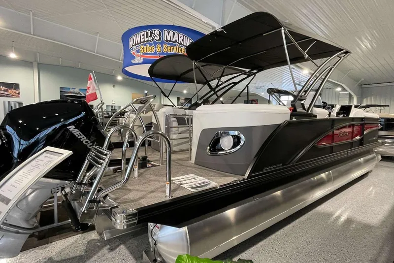 Slide: The Image of 2022 Barletta Corsa Arch 230 pontoon boat displayed at Howell's Marine showroom. - 2