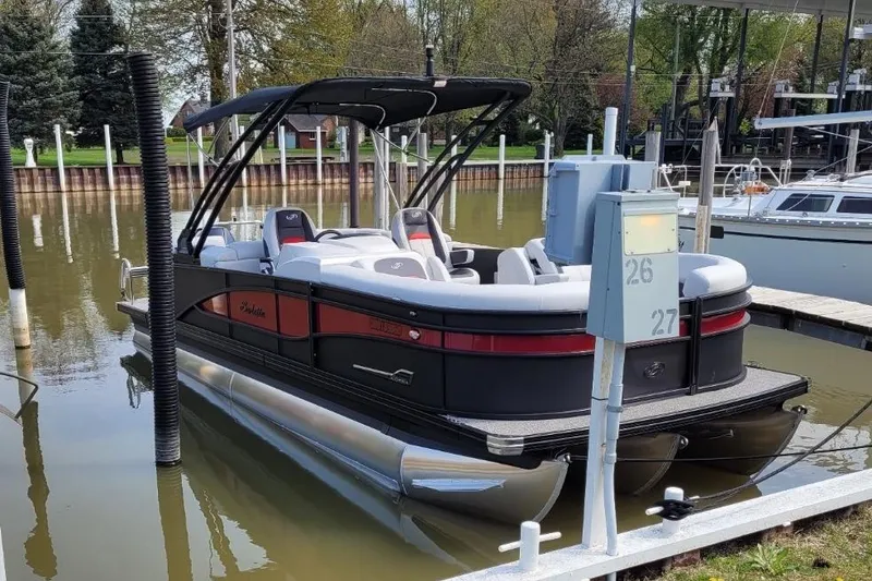 Slide: The Image of 2022 Barletta Corsa Arch 230 pontoon boat docked in a marina. - 4