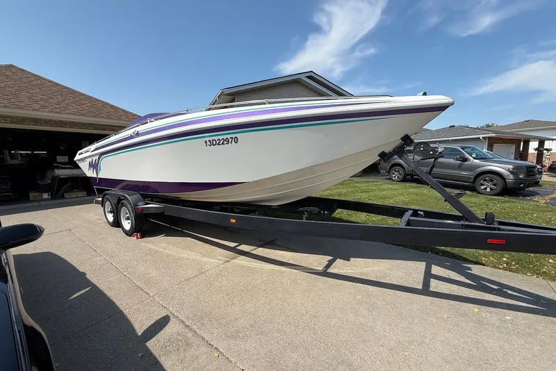 Slide: The Image of 1995 Checkmate Persuader 261 boat on trailer in driveway, sunny day. - 13