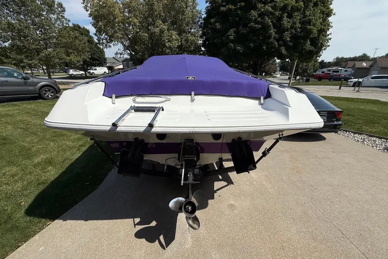 Slide: The Image of 1995 Checkmate Persuader 261 boat with purple cover, parked on driveway. - 17