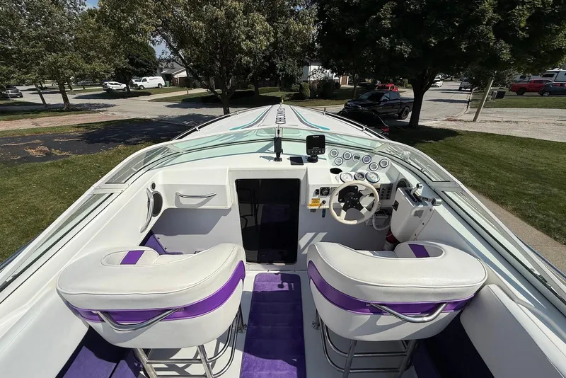Slide: The Image of Interior of a 1995 Checkmate Persuader 261 boat with white and purple seating. - 26