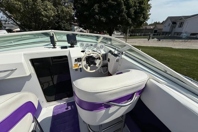 Slide: The Image of Interior of a 1995 Checkmate Persuader 261 boat with white and purple seating. - 27