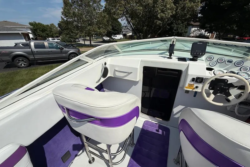 Slide: The Image of Interior of a 1995 Checkmate Persuader 261 boat with white and purple seating. - 28