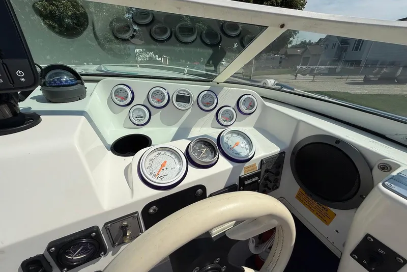 Slide: The Image of Dashboard of a 1995 Checkmate Persuader 261 boat with gauges and controls. - 32