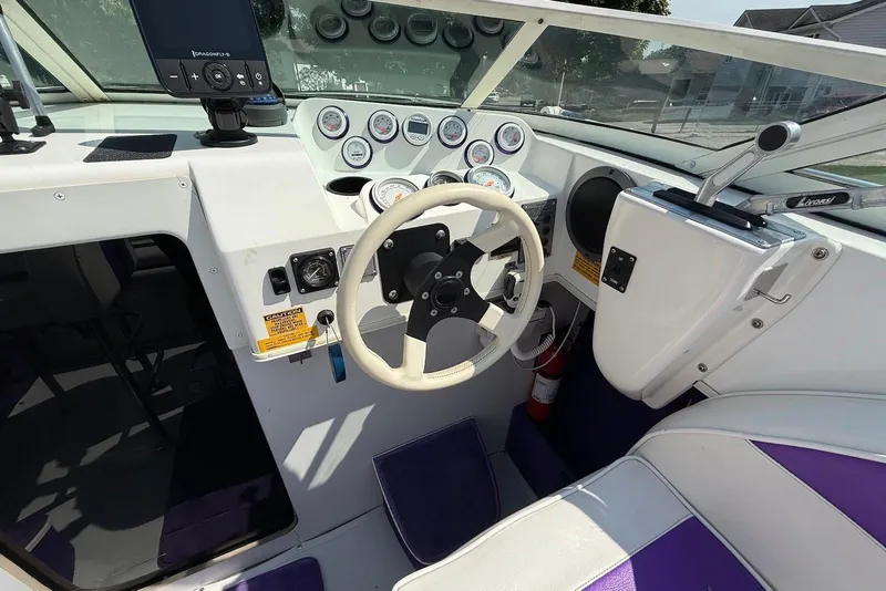 Slide: The Image of Interior of a 1995 Checkmate Persuader 261 boat with steering wheel and gauges. - 33