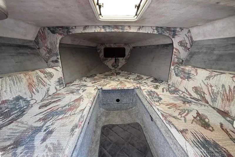 Slide: The Image of Interior cabin of a 1995 Checkmate Persuader 261 boat with patterned upholstery. - 34