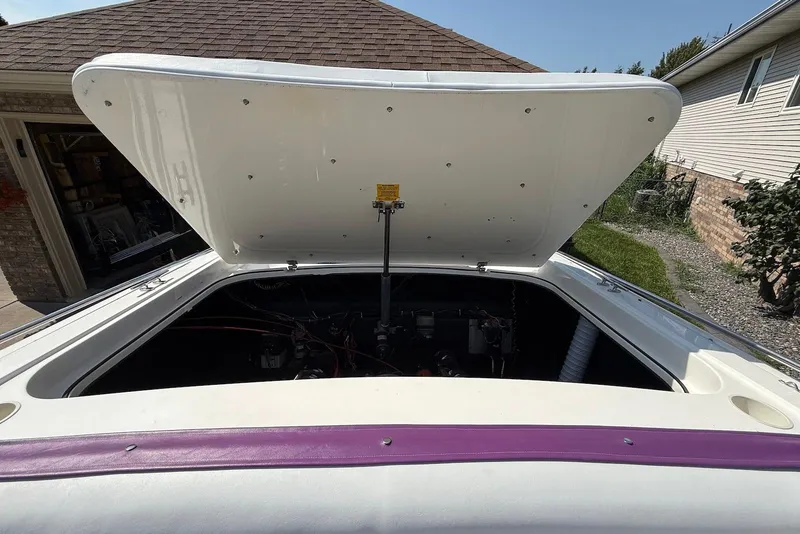 Slide: The Image of Open engine compartment of a 1995 Checkmate Persuader 261 boat, showing interior details. - 36