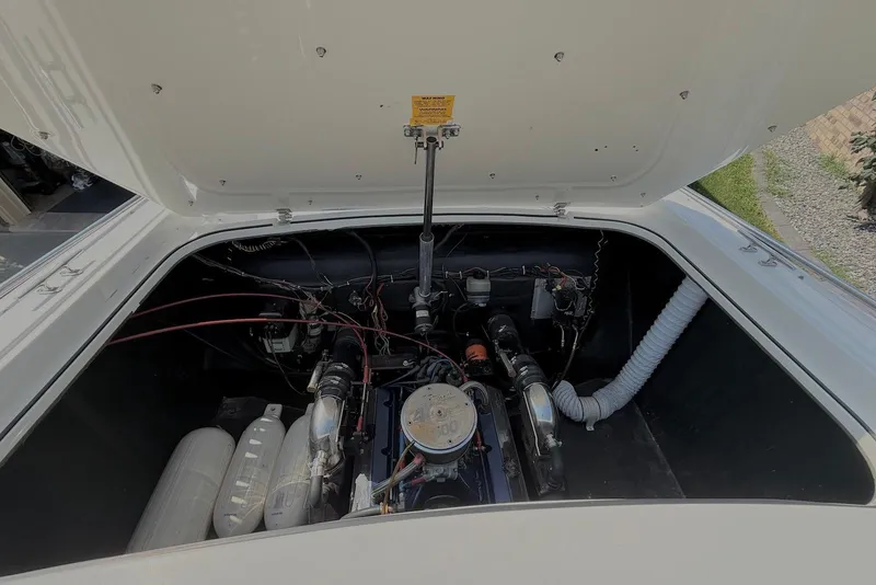 Slide: The Image of Engine compartment of a 1995 Checkmate Persuader 261 boat, showing detailed components. - 37