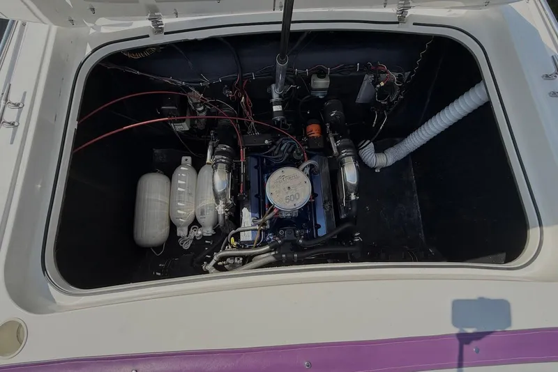 Slide: The Image of Engine compartment of a 1995 Checkmate Persuader 261 boat, showcasing detailed components. - 39