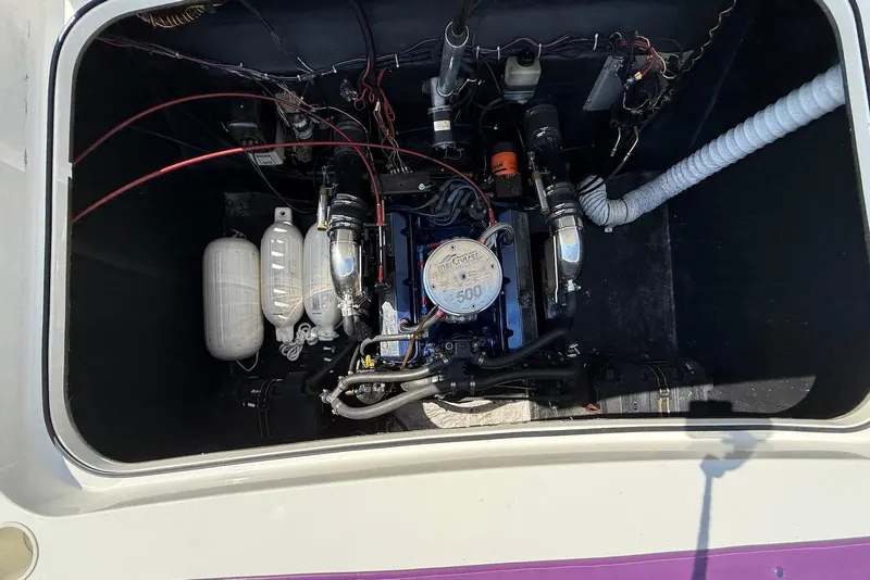 Slide: The Image of Engine compartment of a 1995 Checkmate Persuader 261 boat, showcasing detailed components. - 40