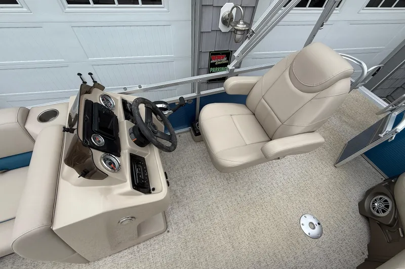 Slide: The Image of Interior of 2020 Avalon Venture Cruise 18' boat with beige captain's chair and control panel. - 11