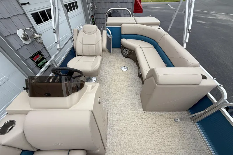 Slide: The Image of 2020 Avalon Venture Cruise 18' pontoon boat interior with beige seating and steering console. - 12