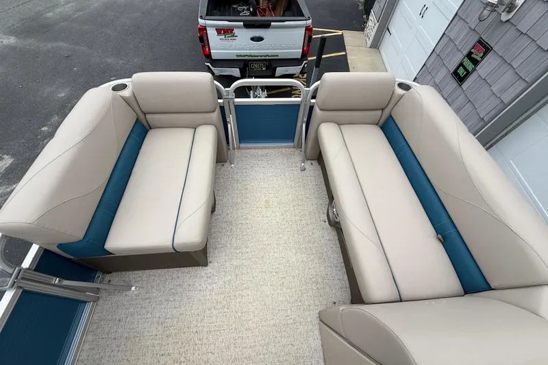 Slide: The Image of 2020 Avalon Venture Cruise 18' pontoon boat with beige and blue seating. - 13