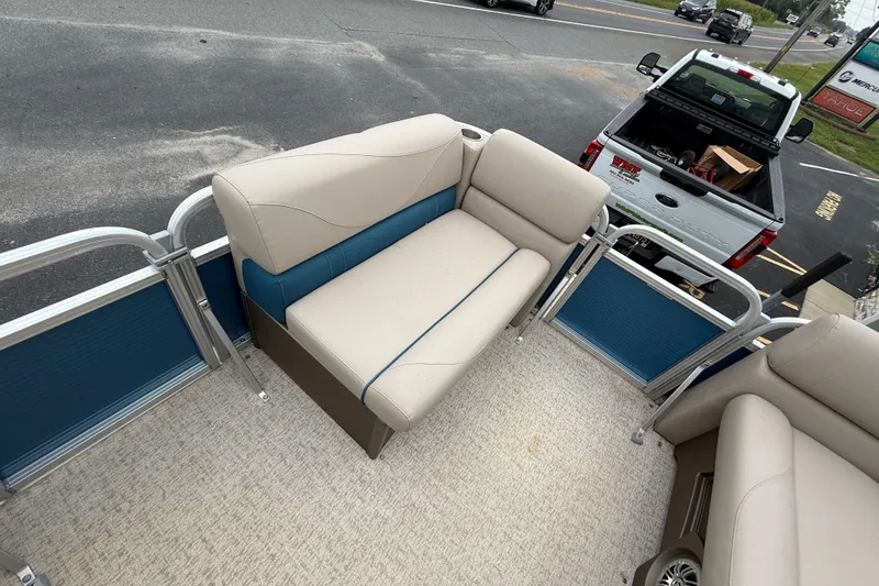 Slide: The Image of 2020 Avalon Venture Cruise 18' pontoon boat interior with beige and blue seating. - 14