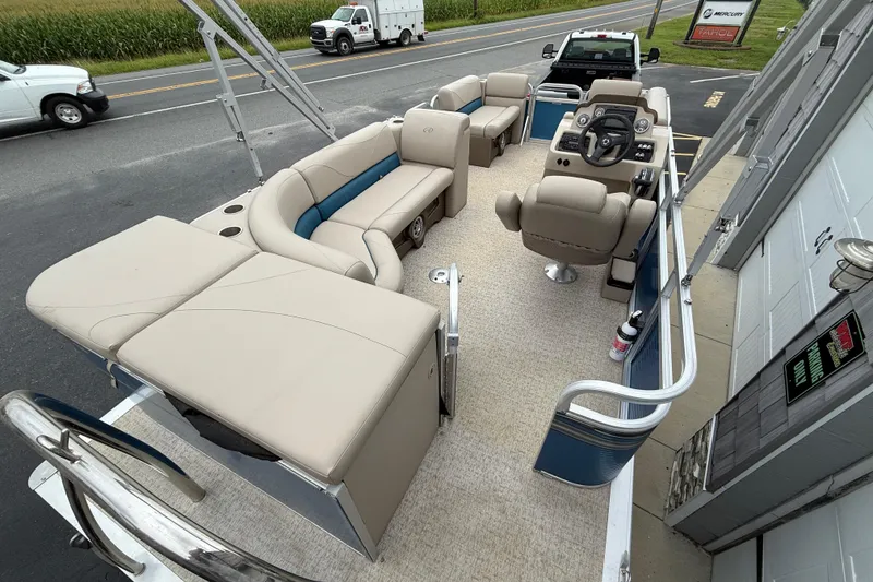 Slide: The Image of 2020 Avalon Venture Cruise 18' pontoon boat with beige seating and modern dashboard. - 19