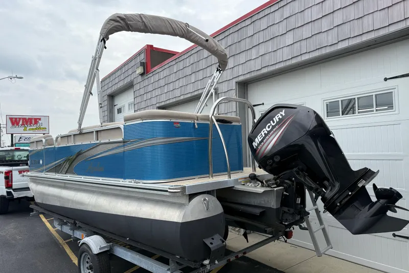 Slide: The Image of 2020 Avalon Venture Cruise 18' pontoon boat with Mercury outboard motor on trailer. - 6