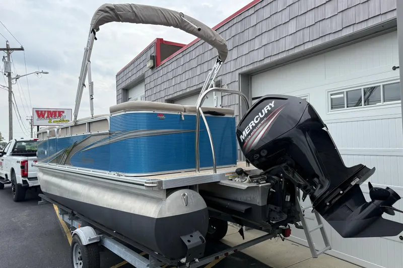 Slide: The Image of 2020 Avalon Venture Cruise 18' pontoon boat with Mercury outboard motor on trailer. - 7