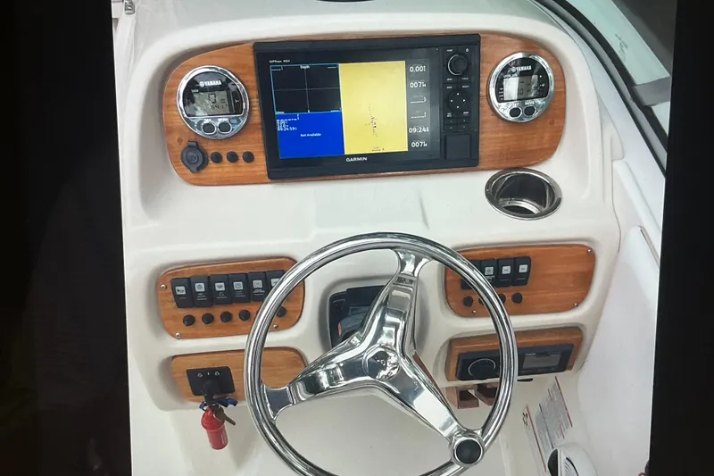 Slide: The Image of 2019 Robalo R207 Dual Console dashboard with Garmin display and Yamaha gauges. - 13
