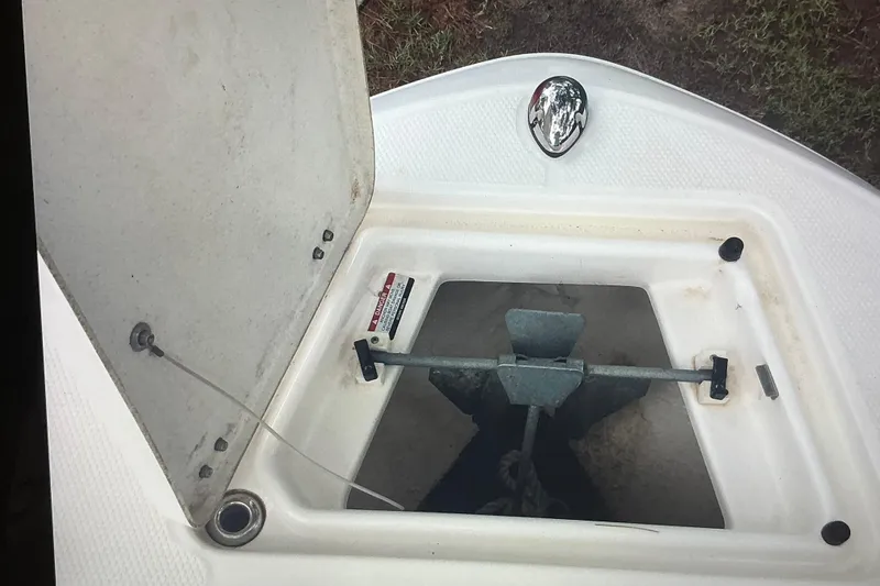 Slide: The Image of Open anchor compartment on 2019 Robalo R207 Dual Console boat. - 16
