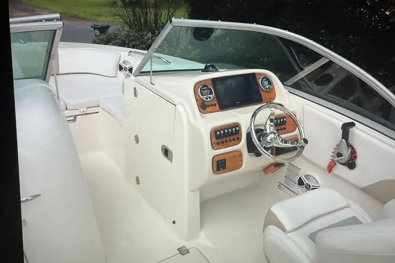 Slide: The Image of 2019 Robalo R207 Dual Console boat interior with steering wheel and dashboard controls. - 20