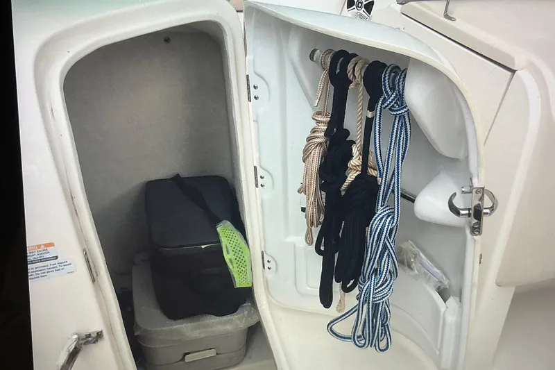 Slide: The Image of 2019 Robalo R207 Dual Console storage compartment with ropes and equipment. - 21
