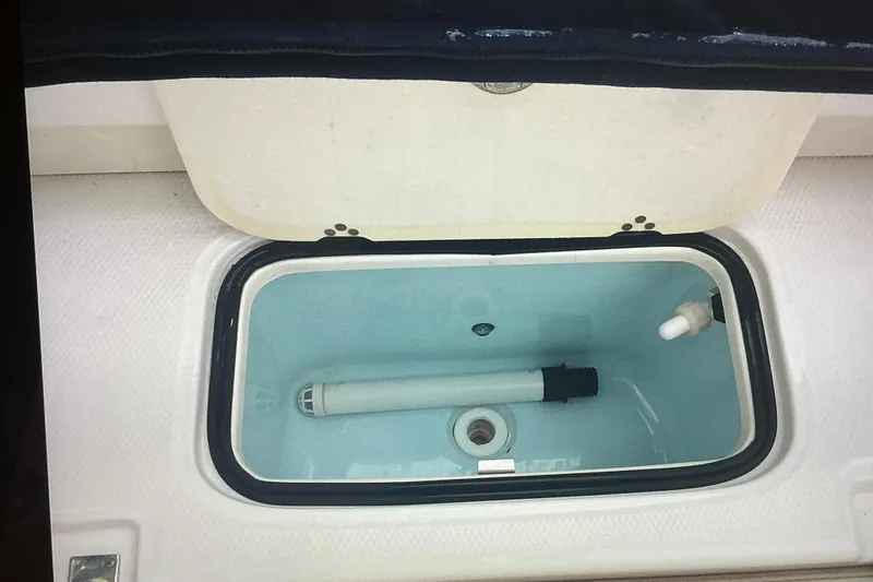 Slide: The Image of 2019 Robalo R207 Dual Console livewell with open lid and plumbing components. - 27