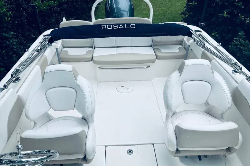 Slide: The Image of 2019 Robalo R207 Dual Console boat interior with white seating and sleek design. - 5