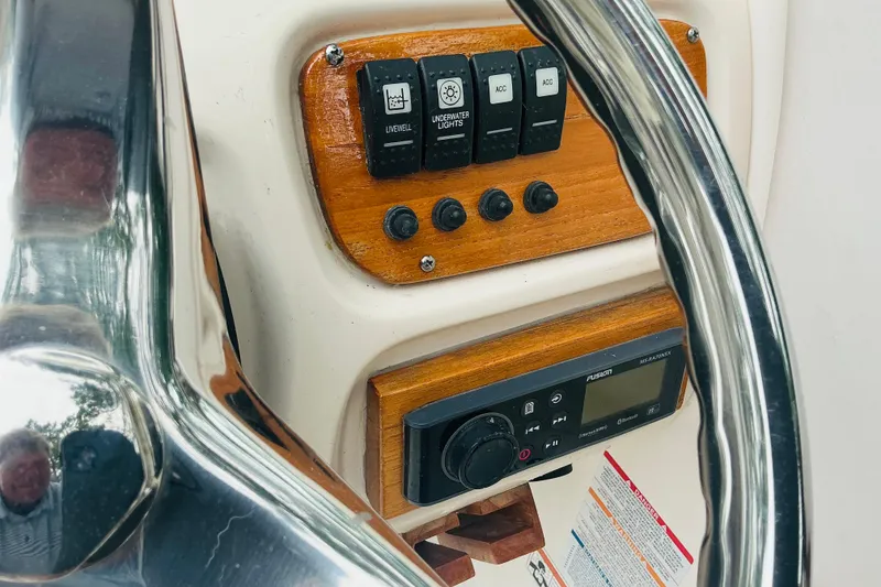 Slide: The Image of 2019 Robalo R207 Dual Console dashboard with controls and steering wheel. - 6