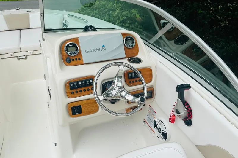 Slide: The Image of 2019 Robalo R207 Dual Console boat dashboard with Garmin navigation system and steering wheel. - 8