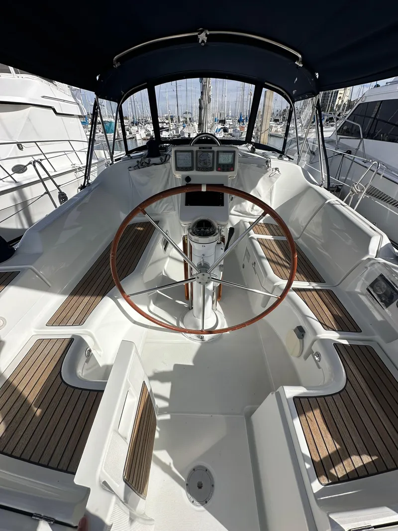 Slide: The Image of 2005 Beneteau 373 sailboat cockpit with wooden accents and steering wheel. - 10