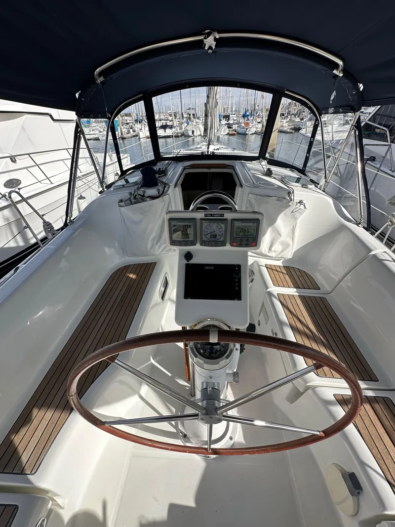 Slide: The Image of 2005 Beneteau 373 sailboat cockpit with wooden accents and navigation instruments. - 11