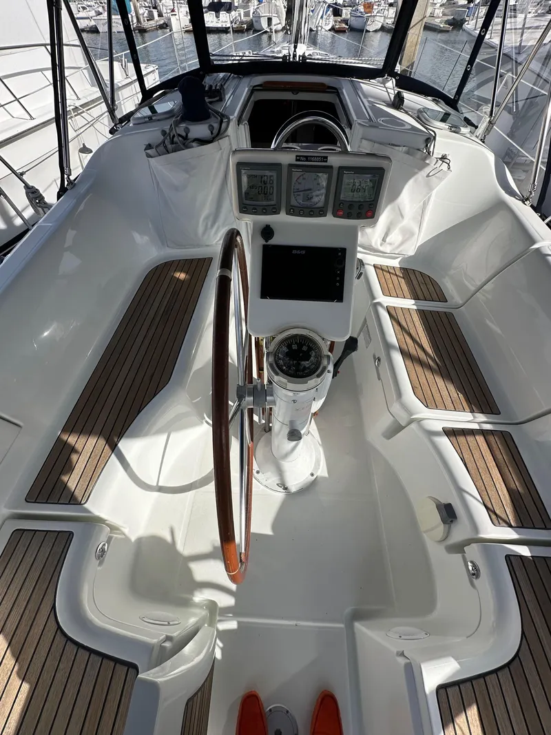 Slide: The Image of 2005 Beneteau 373 sailboat cockpit with steering wheel and navigation instruments. - 12