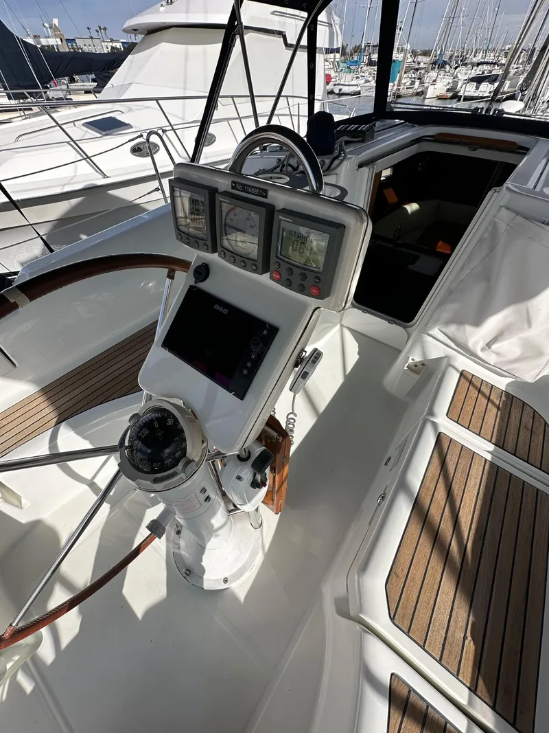 Slide: The Image of 2005 Beneteau 373 sailboat cockpit with navigation instruments and wooden deck. - 13