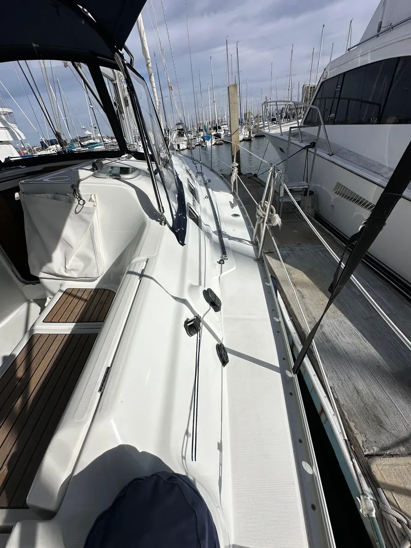 Slide: The Image of 2005 Beneteau 373 sailboat docked at marina, showcasing sleek deck design. - 16