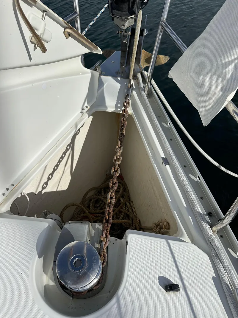 Slide: The Image of Anchor chain and windlass on a 2005 Beneteau 373 sailboat deck. - 20