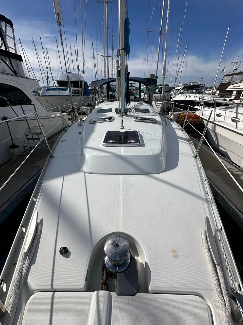 Slide: The Image of 2005 Beneteau 373 sailboat docked, showcasing sleek deck design and marina setting. - 23