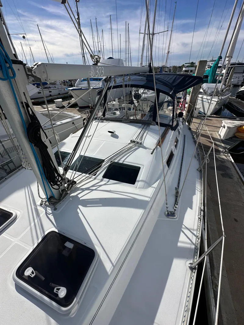 Slide: The Image of 2005 Beneteau 373 sailboat docked at marina, showcasing deck and rigging. - 24