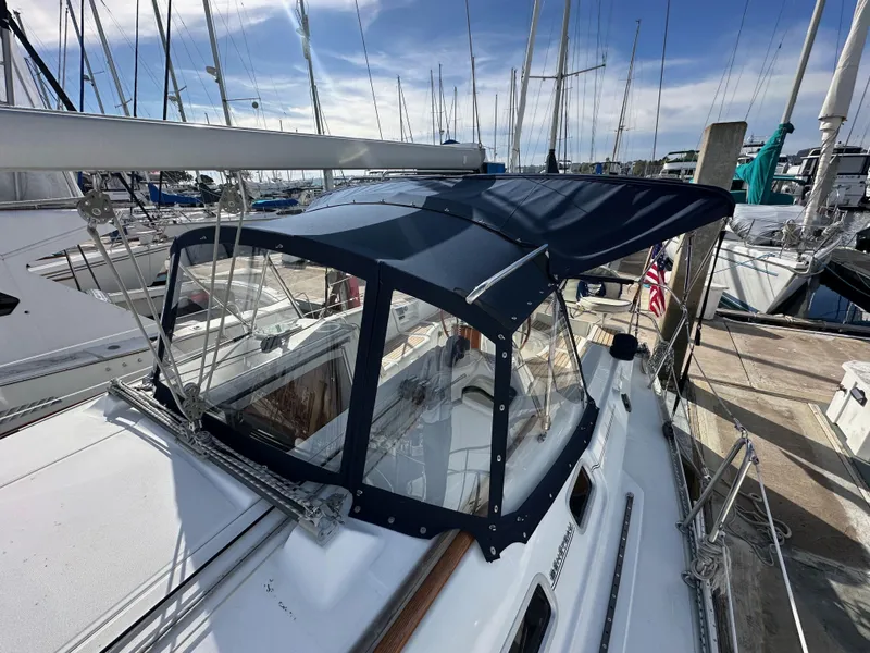 Slide: The Image of 2005 Beneteau 373 sailboat with blue canopy docked at marina. - 25