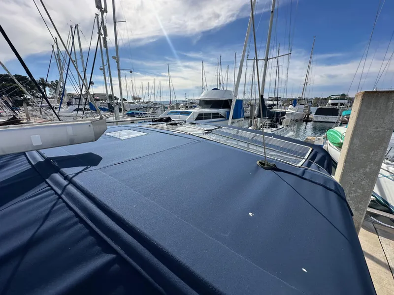 Slide: The Image of 2005 Beneteau 373 sailboat docked in a marina under a clear blue sky. - 26