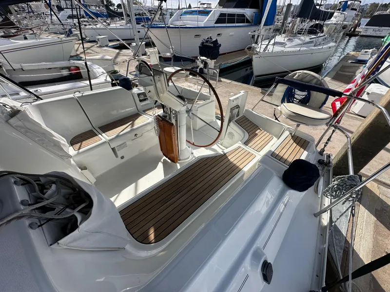 Slide: The Image of 2005 Beneteau 373 sailboat cockpit with wooden deck, docked at marina. - 27