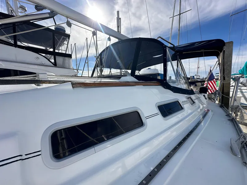 Slide: The Image of 2005 Beneteau 373 sailboat docked, featuring sleek design and American flag. - 3