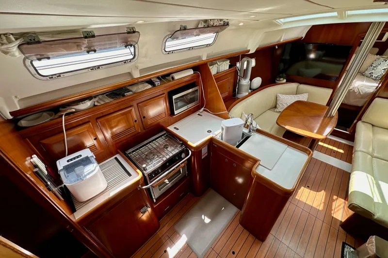 Slide: The Image of Luxurious interior of a 2005 Beneteau 373 sailboat with modern kitchen and seating area. - 30