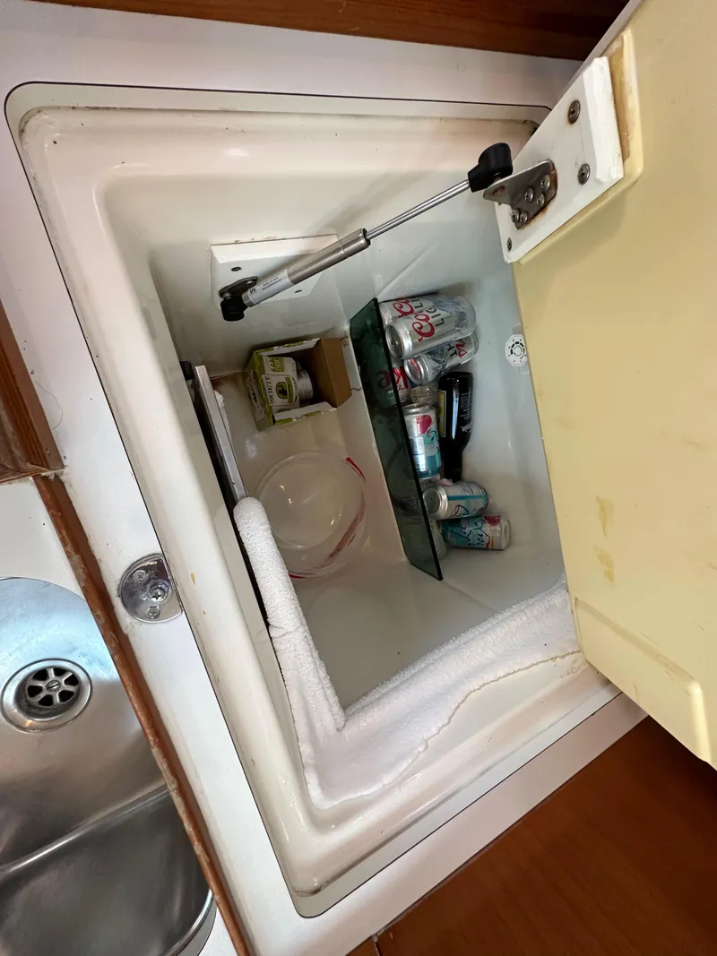 Slide: The Image of Open fridge in 2005 Beneteau 373 yacht with drinks and food items inside. - 34