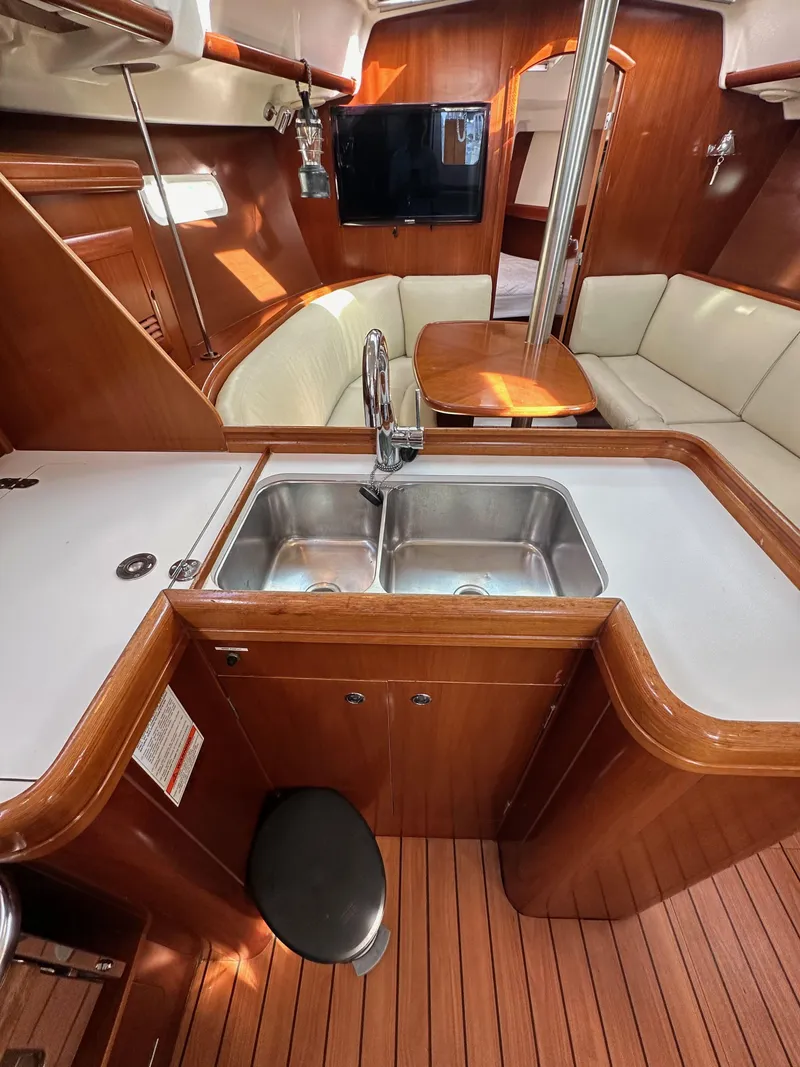 Slide: The Image of Interior of 2005 Beneteau 373 sailboat with wood finish and modern amenities. - 35