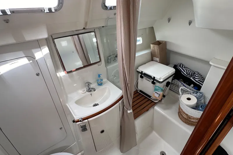 Slide: The Image of 2005 Beneteau 373 yacht bathroom with sink, mirror, and storage space. - 37